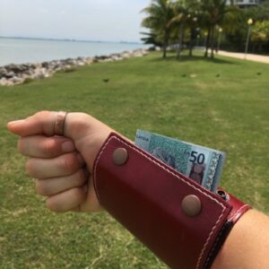 Leather wrist wallet for women worn as a hands-free travel bracelet wallet