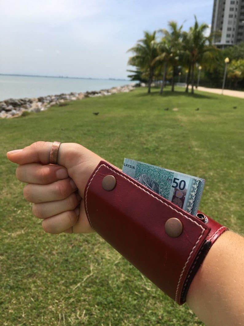 Leather wrist wallet for women worn as a hands-free travel bracelet wallet